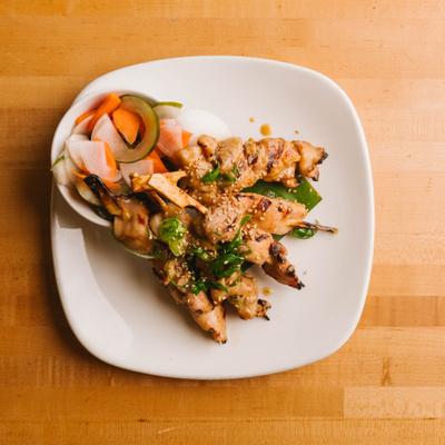Grilled chicken skewers served with vegetables.