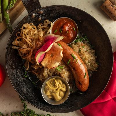 Skillet dish variant with a sausage, sauerkraut, curry ketchup, and mustard.