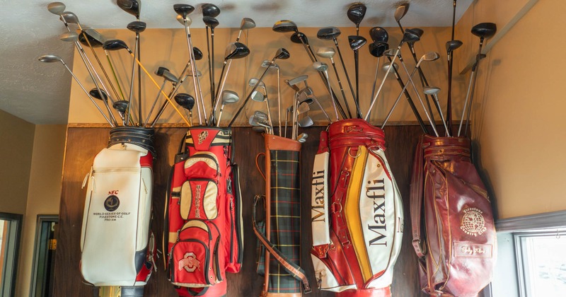 Golf club bags with clubs as wall decoration