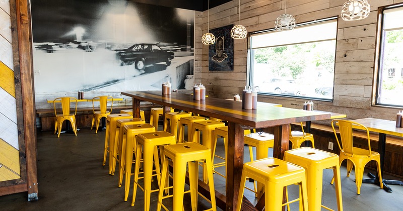 Interior space, dining area, large high table with yellow chairs
