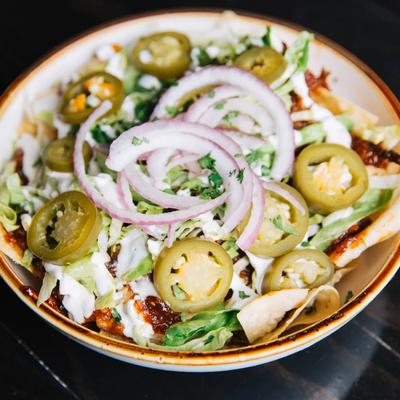 Pulled Pork Nachos, with cheese, jalapenos, red onion, and BBQ sauce.