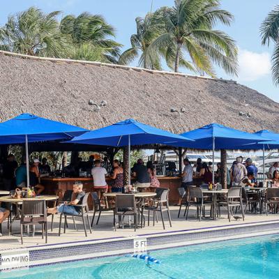 Outdoor patio seating area with parasols by the pool.