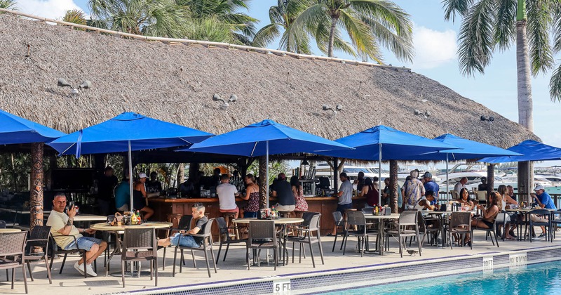 Outdoor patio seating area with parasols by the pool