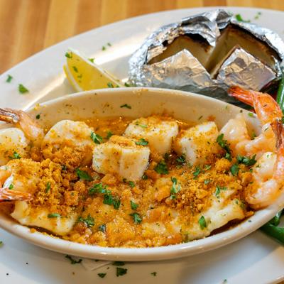 Baked Seafood Platter, with Haddock, jumbo shrimp, scallops, cracker crumbs, and sauce.