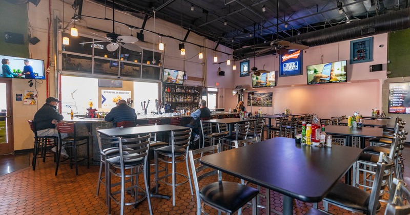 A seating area, and a bar area with barstools