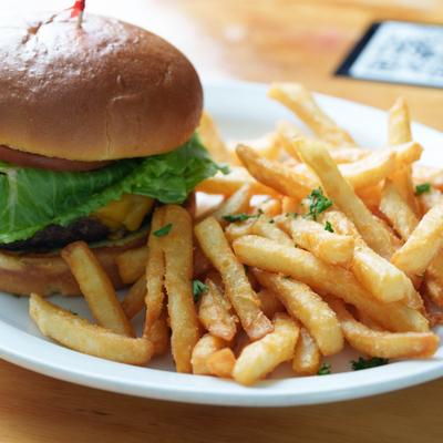 Wagyu Cheese Burger with lettuce, tomato and a side of fries.