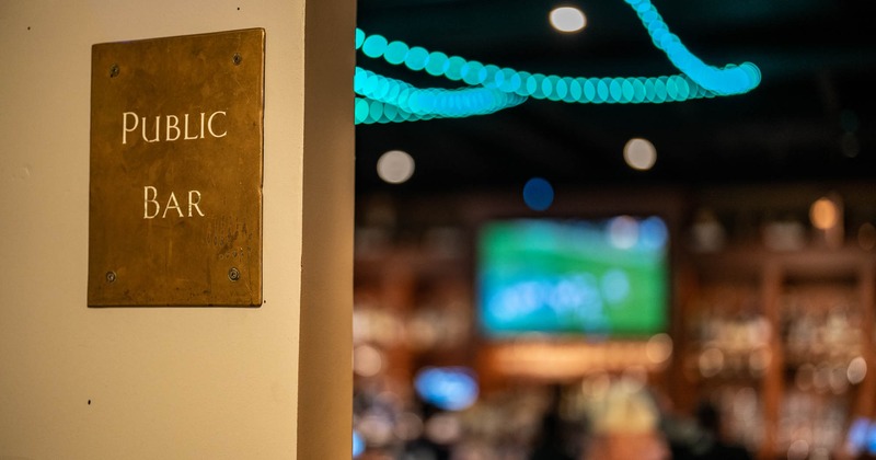 Public bar sign and bar room with tv in background