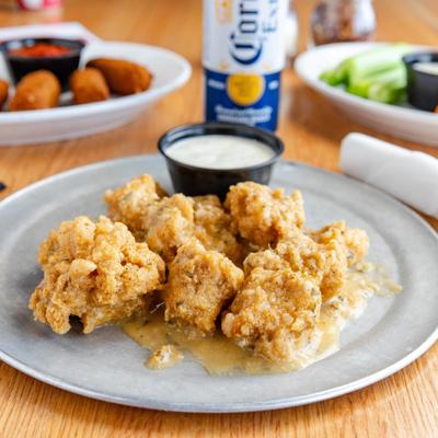 Crispy chicken bites served with dipping sauce.