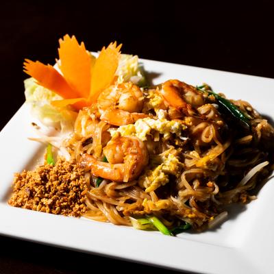 Shrimp Pad Thai with crushed peanuts and vegetables.