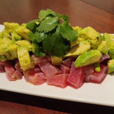 Ahi tuna and avocado cubes with lime sauce and cilantro.