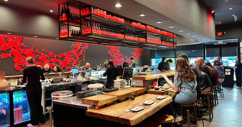 Interior, guests sitting at the bar