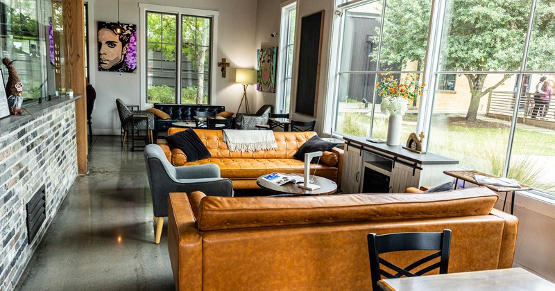 Interior, lounge area, padded three seater sofas with armchairs and coffee tables