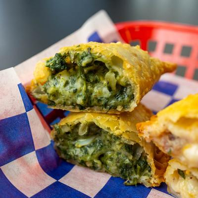 Spinach, ham cheese and pineapple empanda, close up.