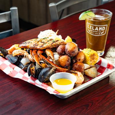 Blackened Seafood Boil served  with a glass of beer.