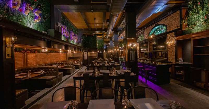 Interior, seating area ready for guests, floral decoration on the walls