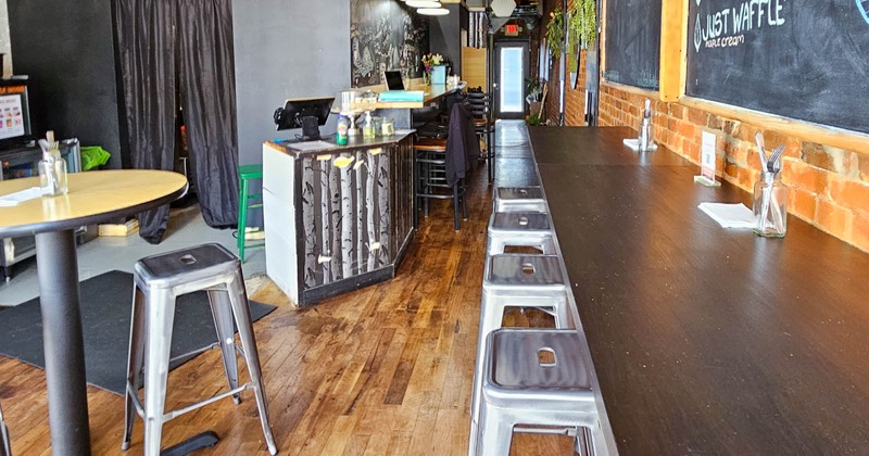 Seating area, with bar stools, high tables, and blackboard menu