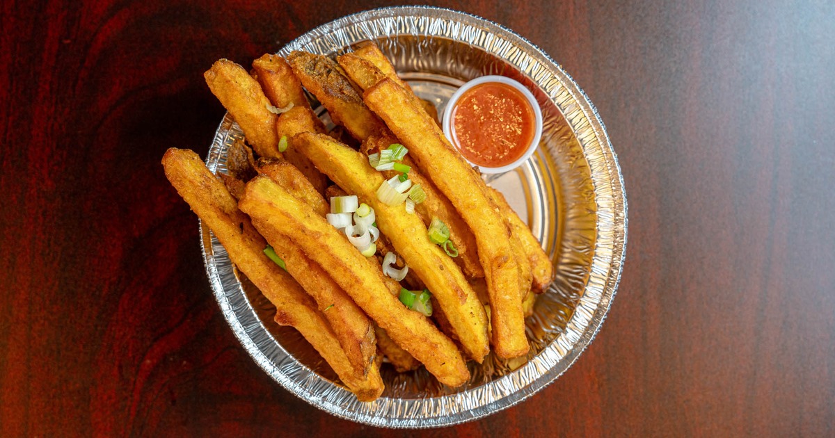 Fried with red dipping sauce and scallions in a foil bowl