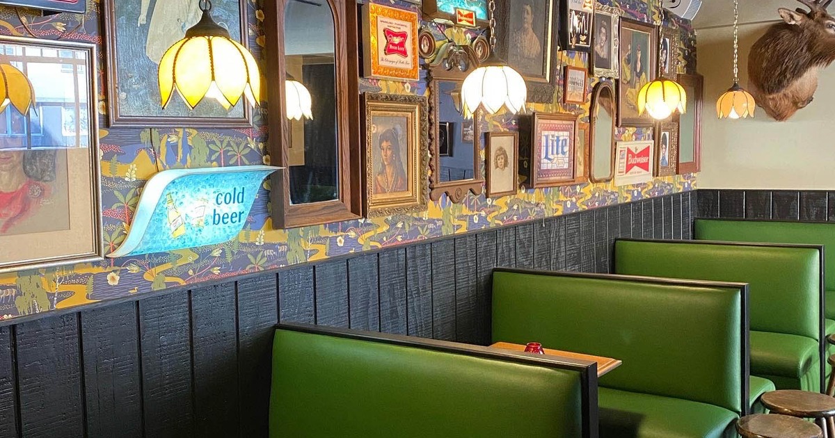 Interior, restaurant booths by a decorated wall