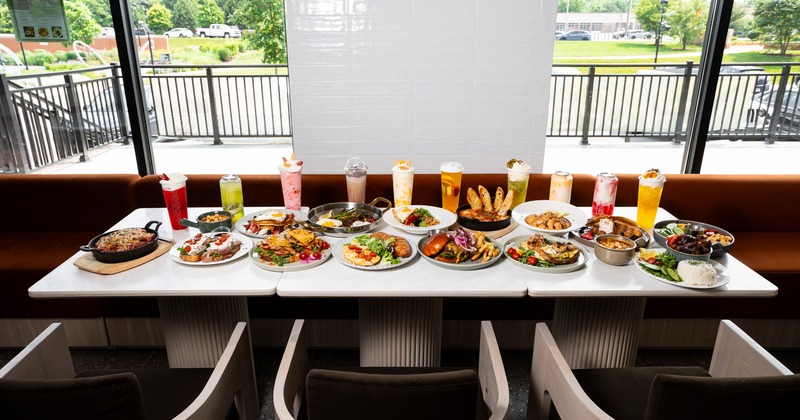 Table by window with assorted dishes, armchairs