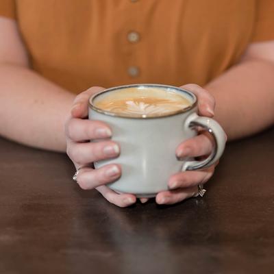 Hands holding a cup.