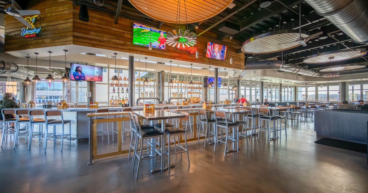 ''Joe's Garage'' interior, high seating tables with stools, large bar, concrete flooring