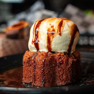 Sticky toffee pudding with vanilla ice cream and chocolate sauce.