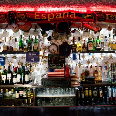 Behind the bar area with bottles and trinkets