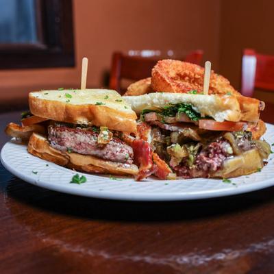 Spicy melt burger served with toasted bread slices.
