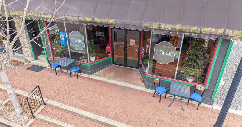 Exterior, entrance with two tables and chairs