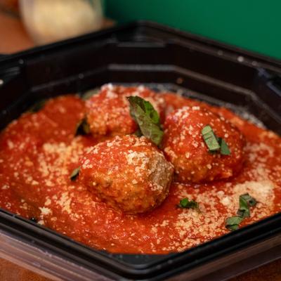 Mama's Meatball Bites served with marinara, grated parmesan, and fresh basil.