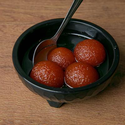 Fried dough balls soaked in a sweet, sticky sugar syrup.