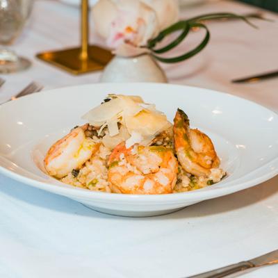 Shrimp risotto topped with shaved Parmesan.