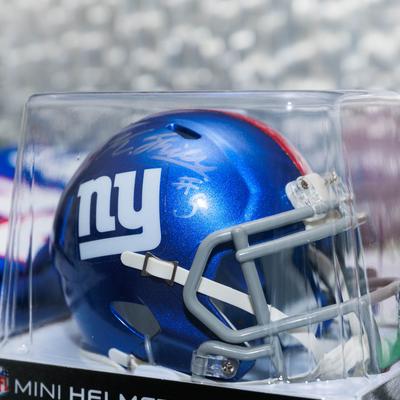 Blue football helmet displayed inside a clear case.
