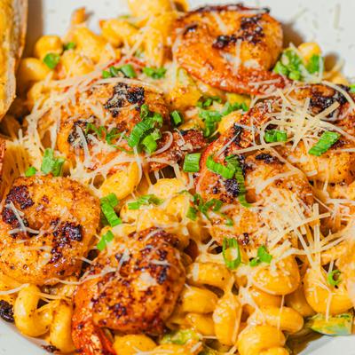 Cajun shrimp pasta served with garlic bread.