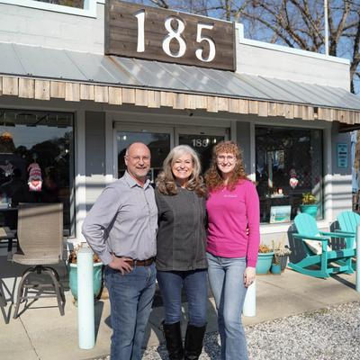 The owners standing in front of the restaurant with prominent signage.