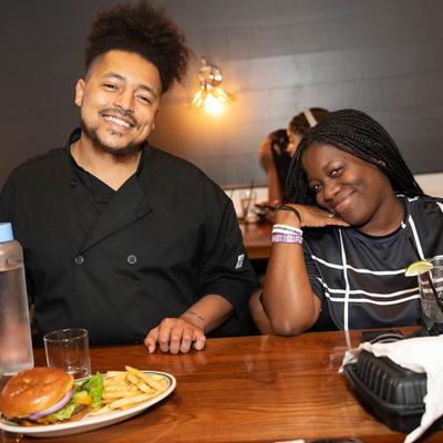 Two people and food on the table in front of them.
