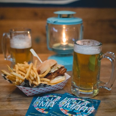 Fried chicken slider served with fries and a glass of beer.