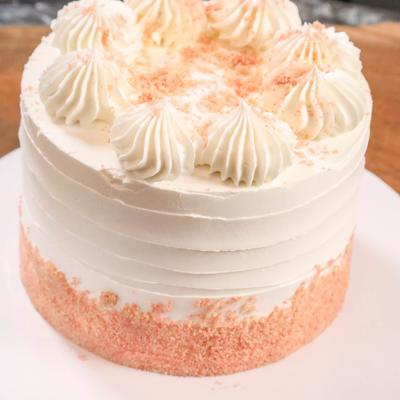 Strawberry vanilla cake on a white plate.