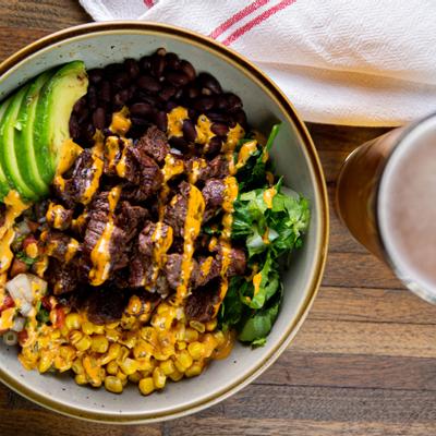 Grilled sliced meat with dip, vegetables on the side