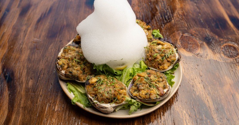 Baked clams with culinary foam in the center