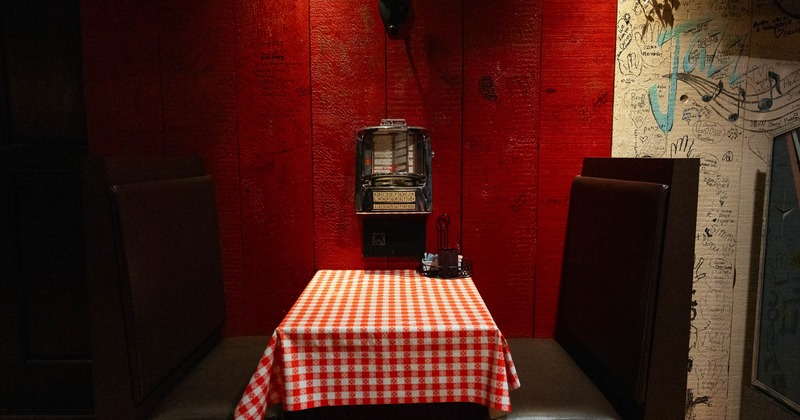Interior, restaurant booth near red wall