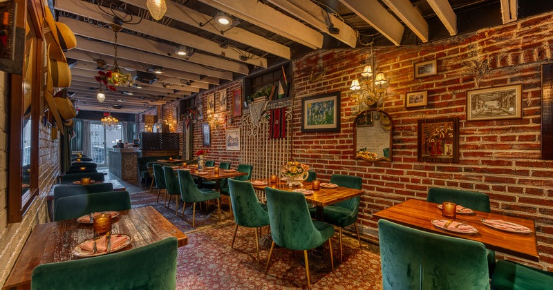 Cozy and stylish restaurant interior with a long, narrow dining area with set dining tables