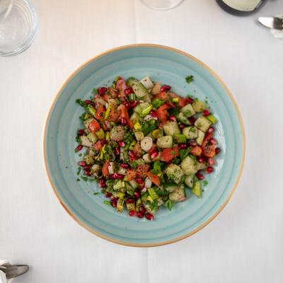 Turkish Salad with chopped cucumbers, tomatoes, scallions, and parsley.