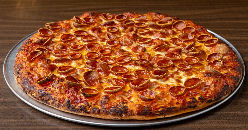Whole Pepperoni pizza served on the table