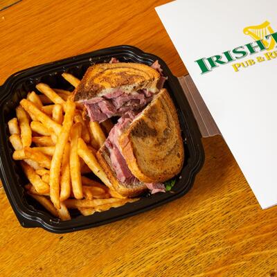 Rich pastrami sandwich and fries.