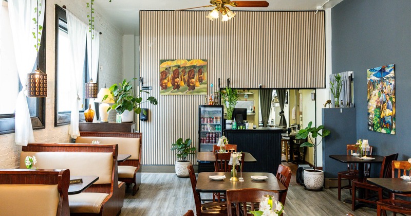 Interior seating area with wooden booths, chairs and tables