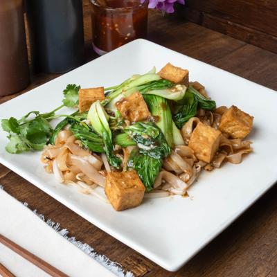 Stir fried tofu noodles with bok choy.