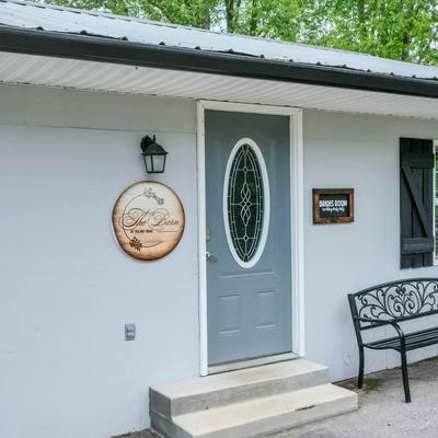 Exterior of a wedding dressing room with an entrance and a metal bench.
