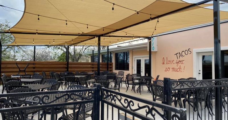 Patio covered with awning, tables and seats