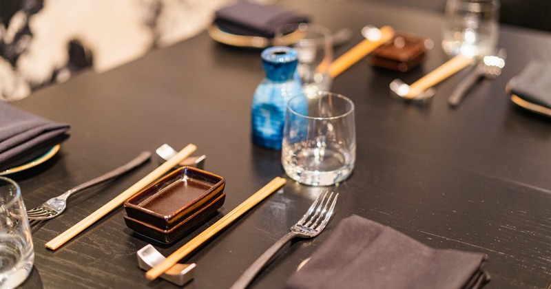Cutlery, glass shots, dining napkins, closeup